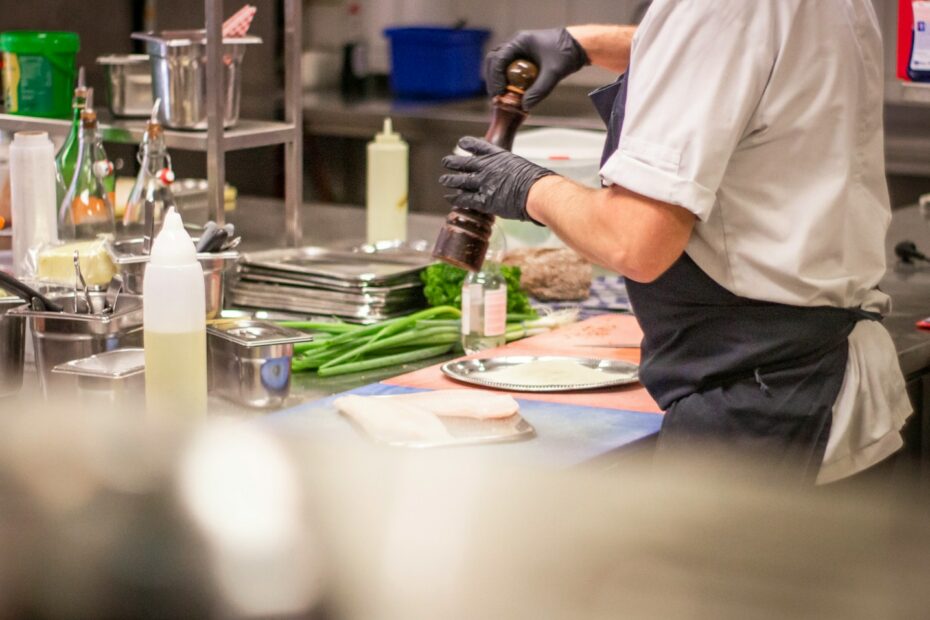 man putting herb on food